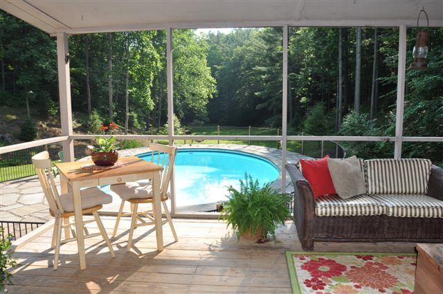 1550 Scout Road Blue Ridge, VA 24064 - Photo 20 of 52 a view of a patio with couches coffee table and chairs with wooden floor