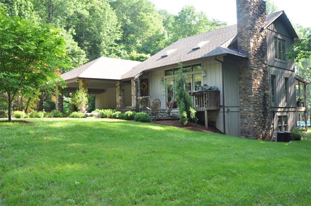 1550 Scout Road Blue Ridge, VA 24064 - Photo 3 of 52 a view of a patio with a table and chairs under an umbrella