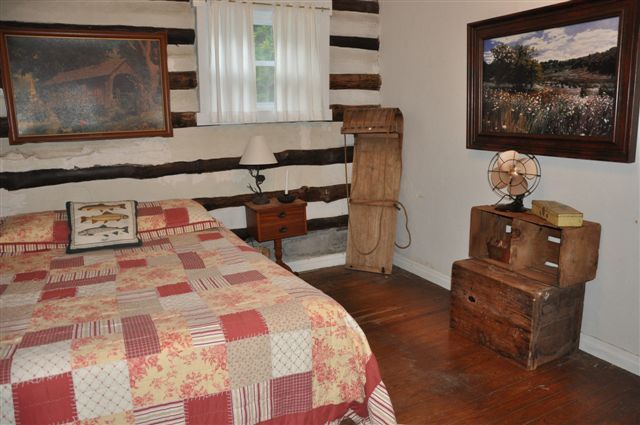 1550 Scout Road Blue Ridge, VA 24064 - Photo 36 of 52 a bedroom with a bed and wooden floor