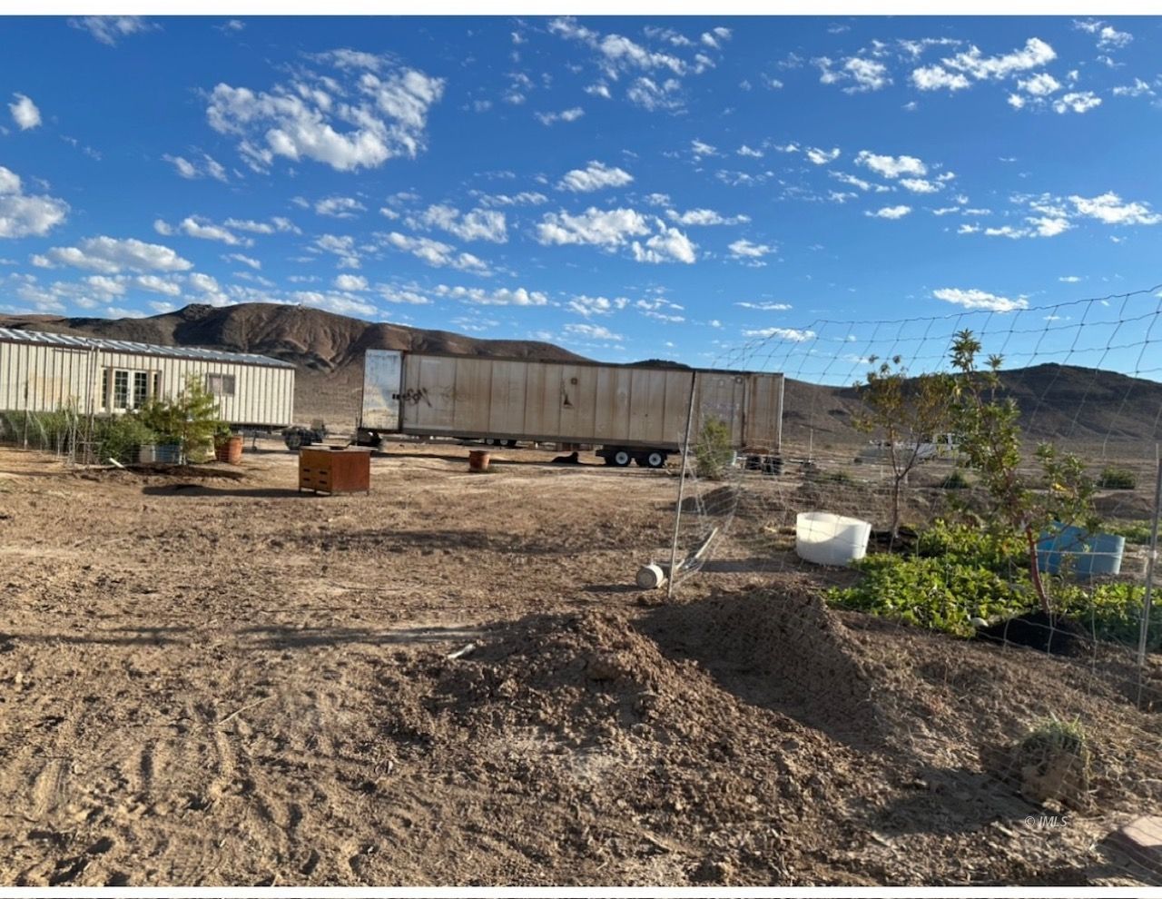147 Agate Street Tecopa, CA 92389 - Photo 1 of 13 a view of a yard with wooden fence
