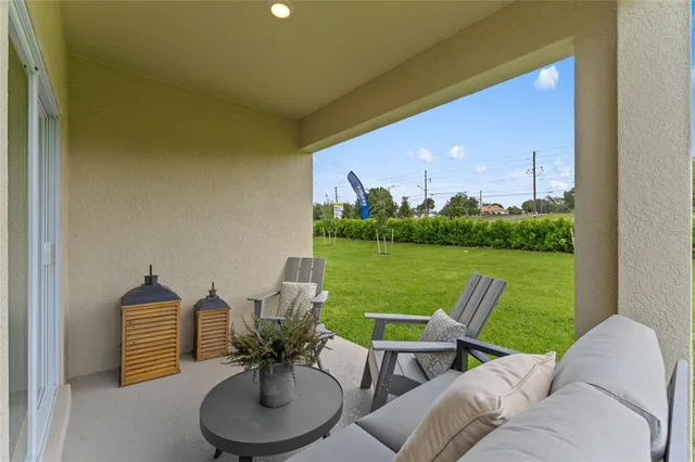 a view of a patio with a table and chairs under an umbrella