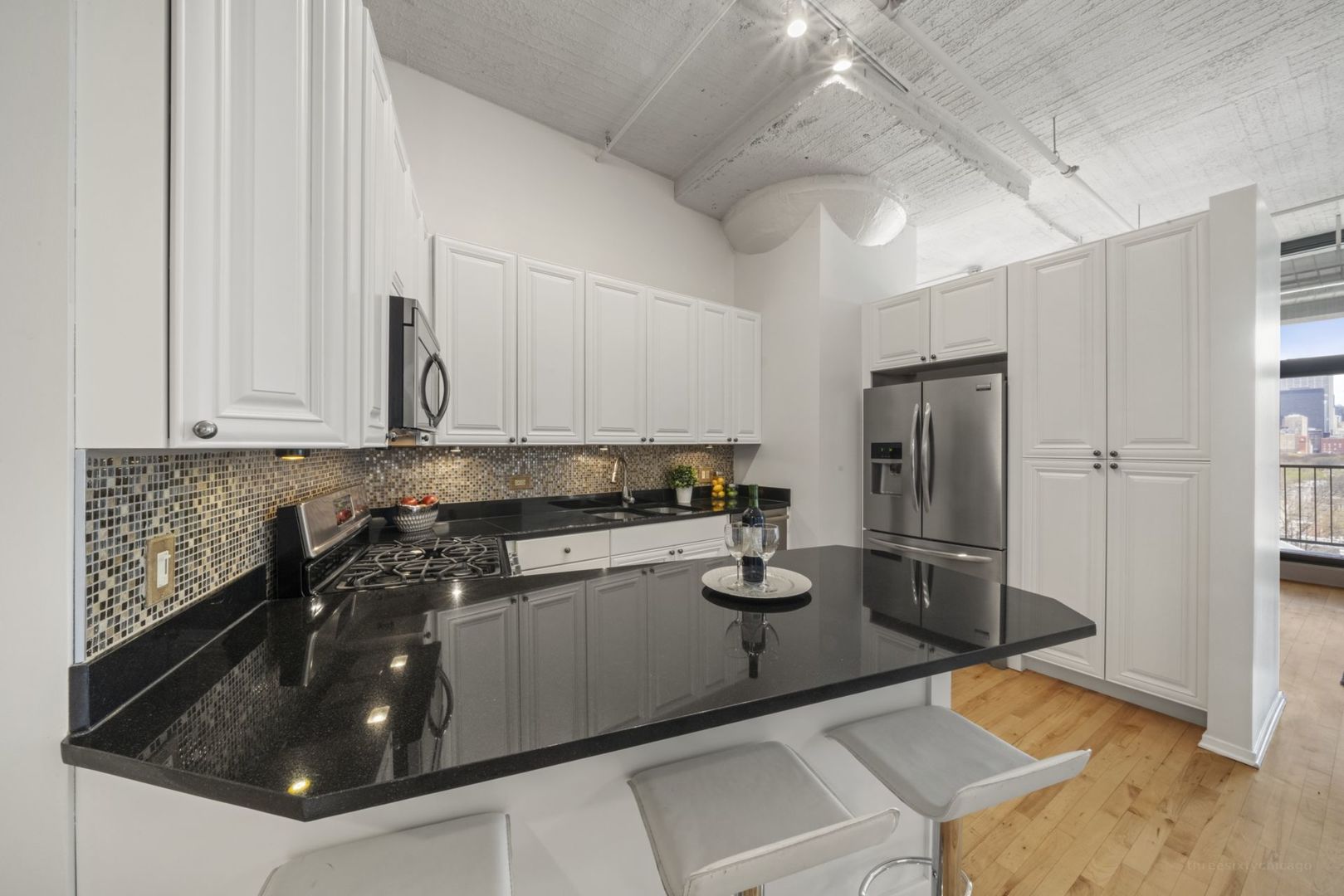 1530 South State Street, Unit 607 Chicago, IL 60605 - Photo 12 of 29 a kitchen with stainless steel appliances granite countertop a sink a stove and a refrigerator