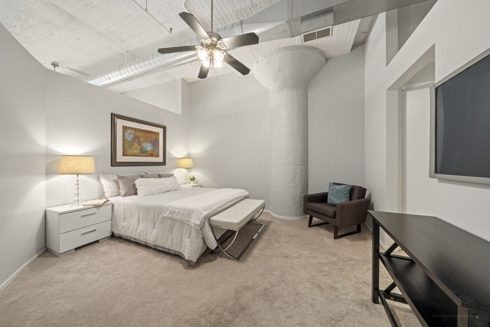 1530 South State Street, Unit 607 Chicago, IL 60605 - Photo 13 of 29 a spacious bedroom with a bed and a chandelier