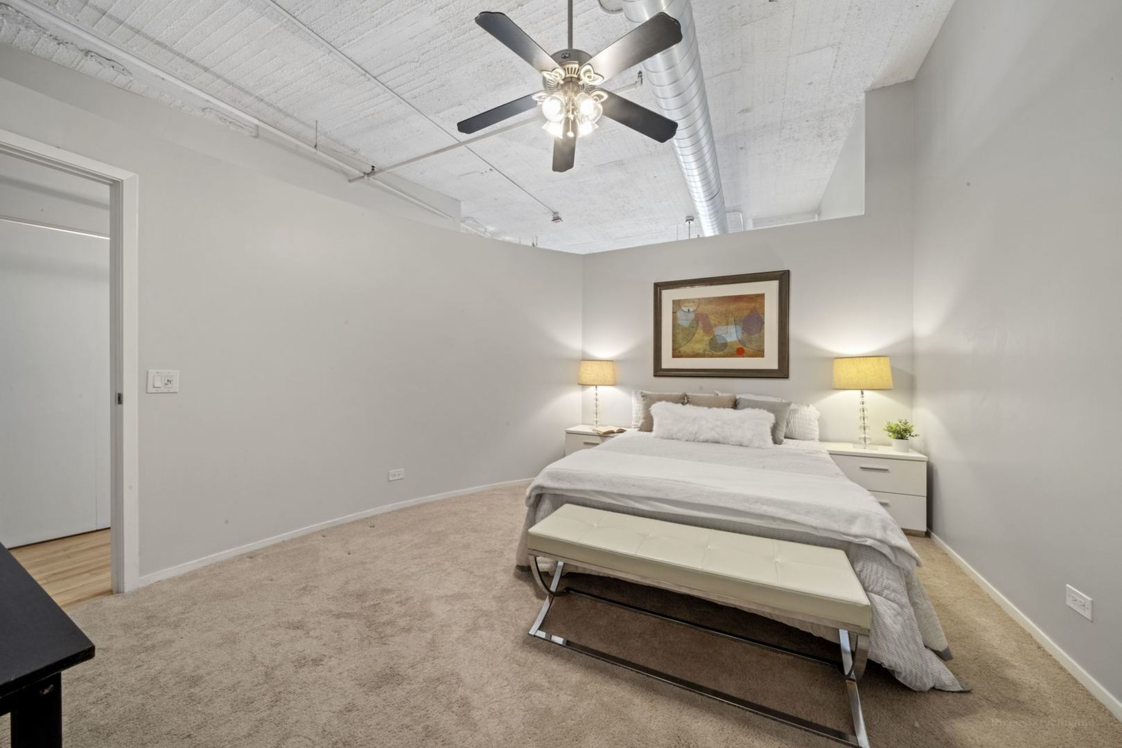 1530 South State Street, Unit 607 Chicago, IL 60605 - Photo 14 of 29 a bedroom with a bed and a chandelier