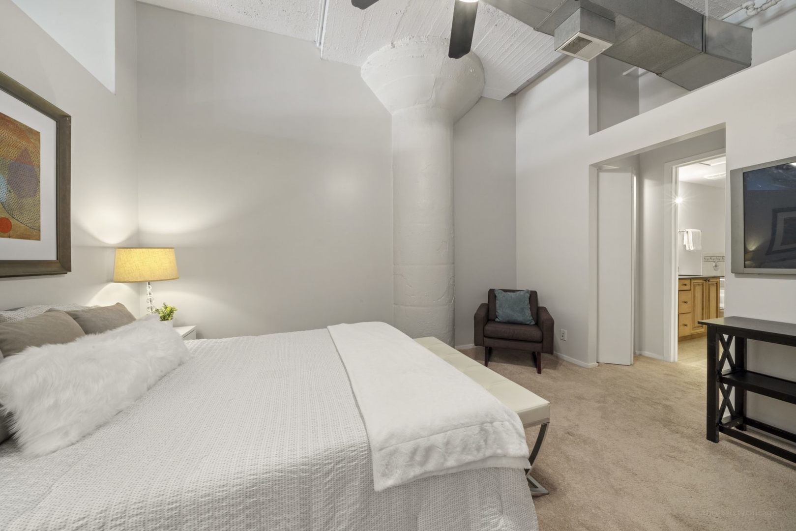 1530 South State Street, Unit 607 Chicago, IL 60605 - Photo 15 of 29 a bedroom with a bed a chair and potted plant on the dresser