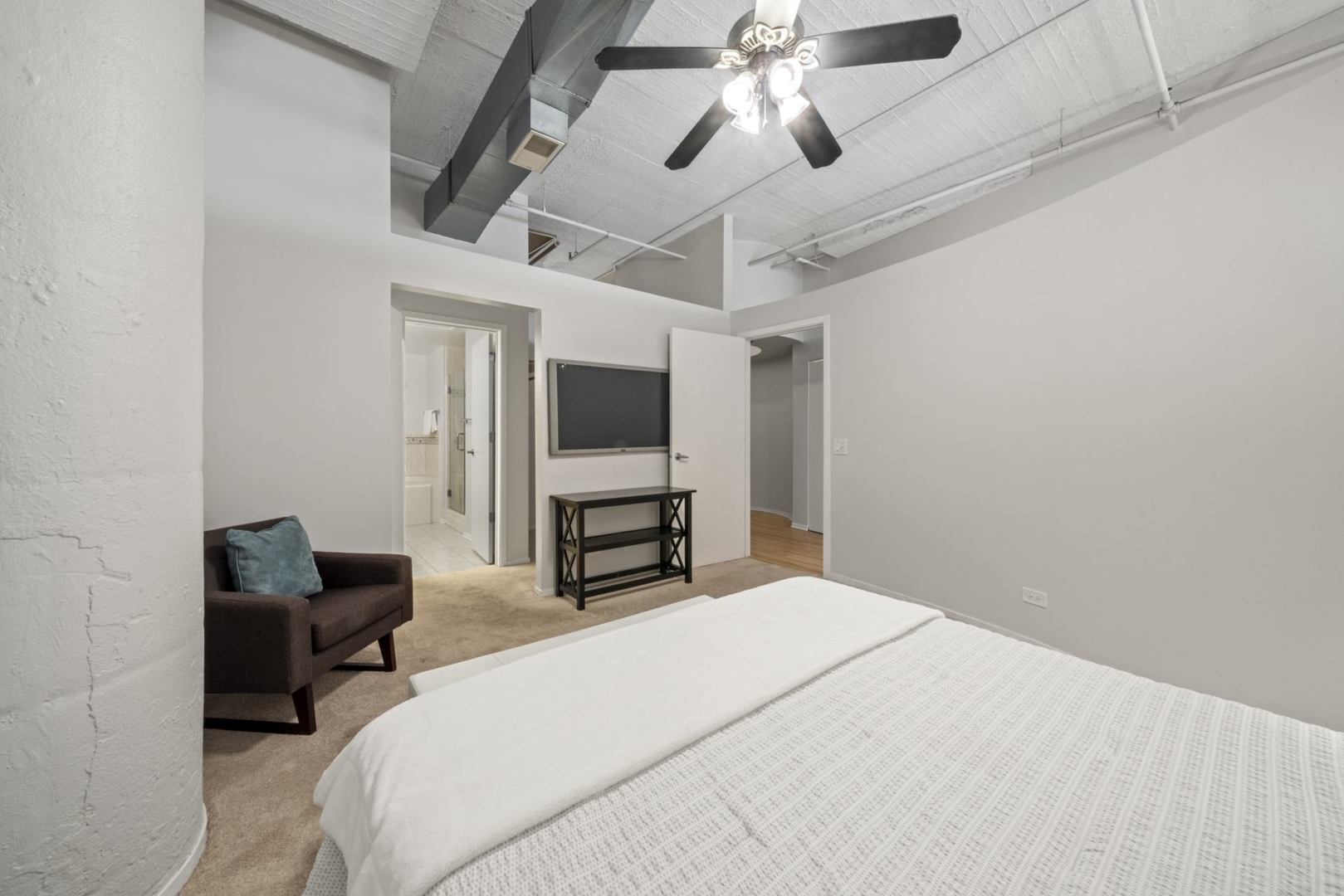 1530 South State Street, Unit 607 Chicago, IL 60605 - Photo 16 of 29 a bedroom with bed and a chandelier