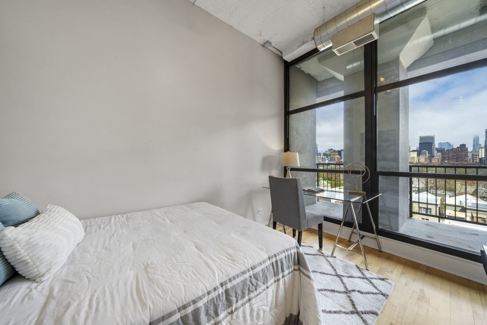 1530 South State Street, Unit 607 Chicago, IL 60605 - Photo 19 of 29 a bedroom with a bed and a table