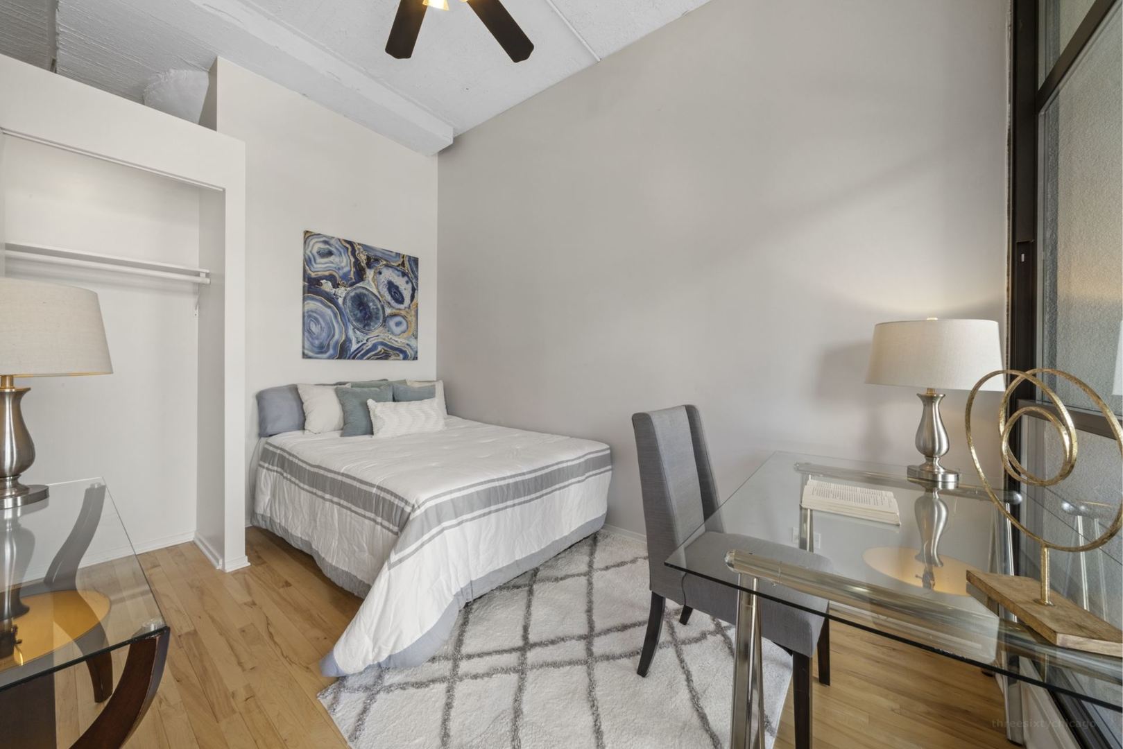 1530 South State Street, Unit 607 Chicago, IL 60605 - Photo 20 of 29 a bedroom with a bed and a table in it