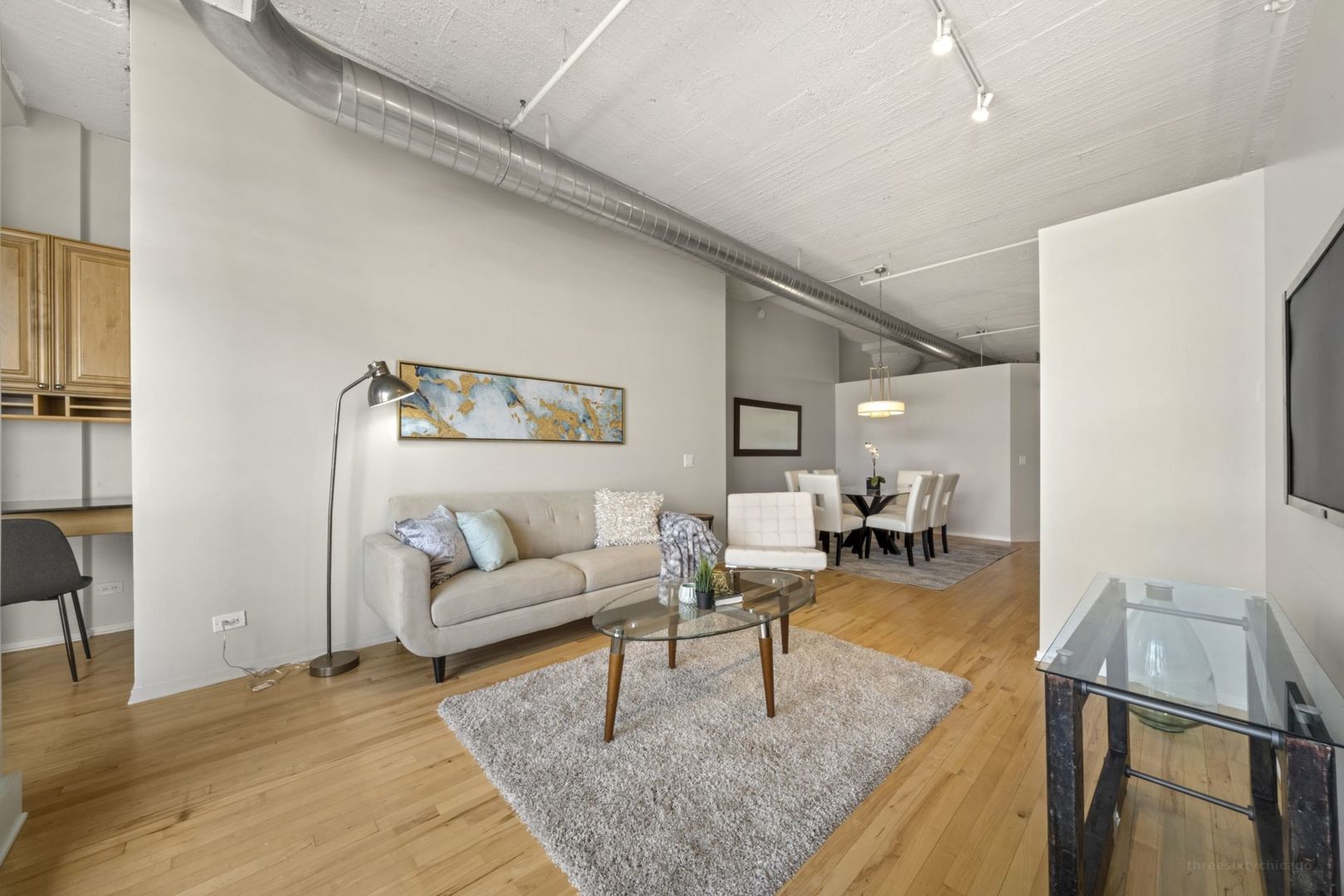 1530 South State Street, Unit 607 Chicago, IL 60605 - Photo 4 of 29 a living room with furniture and a table