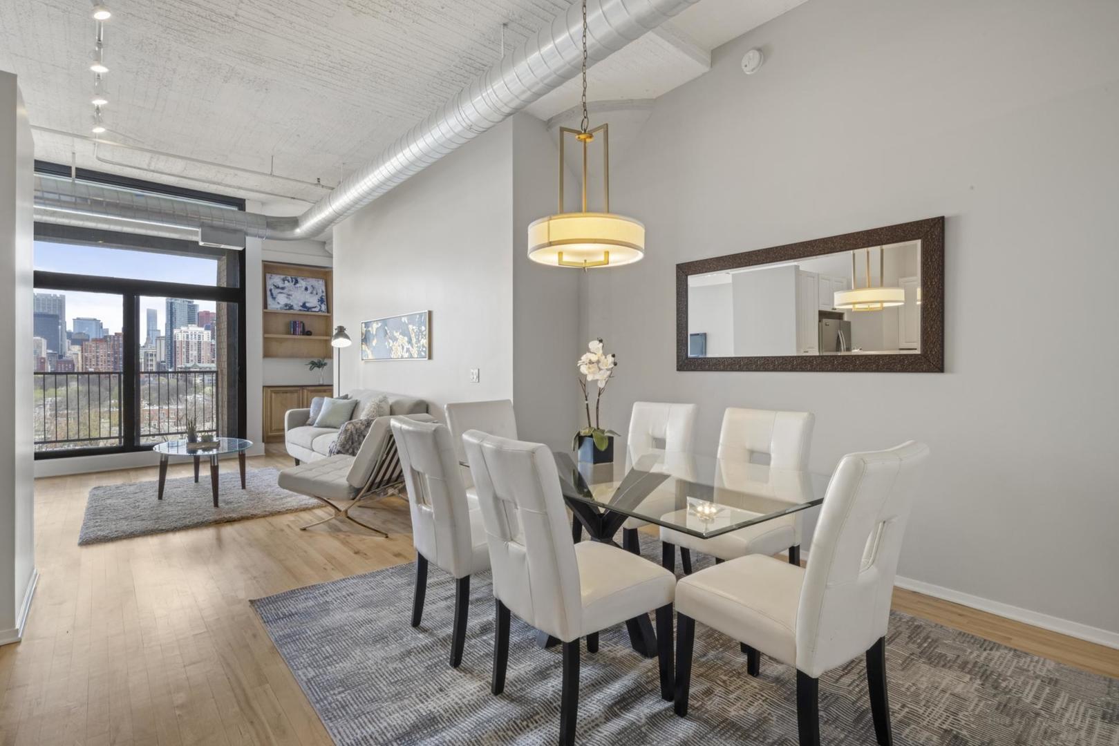 1530 South State Street, Unit 607 Chicago, IL 60605 - Photo 8 of 29 a dining room with wooden floor and a chandelier