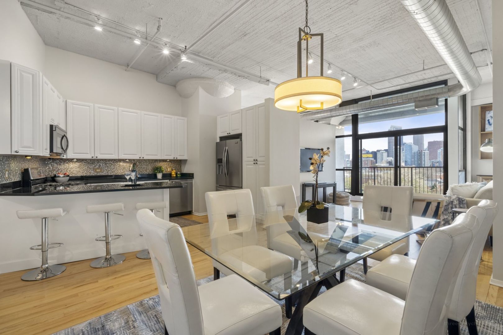 1530 South State Street, Unit 607 Chicago, IL 60605 - Photo 10 of 29 a view of a dining room with furniture a chandelier and wooden floor