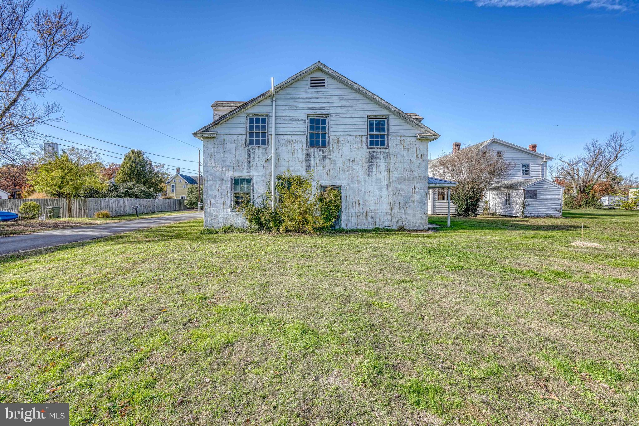 21486 Mission Road Tilghman, MD 21671 - Photo 18 of 32 a front view of a house with a yard