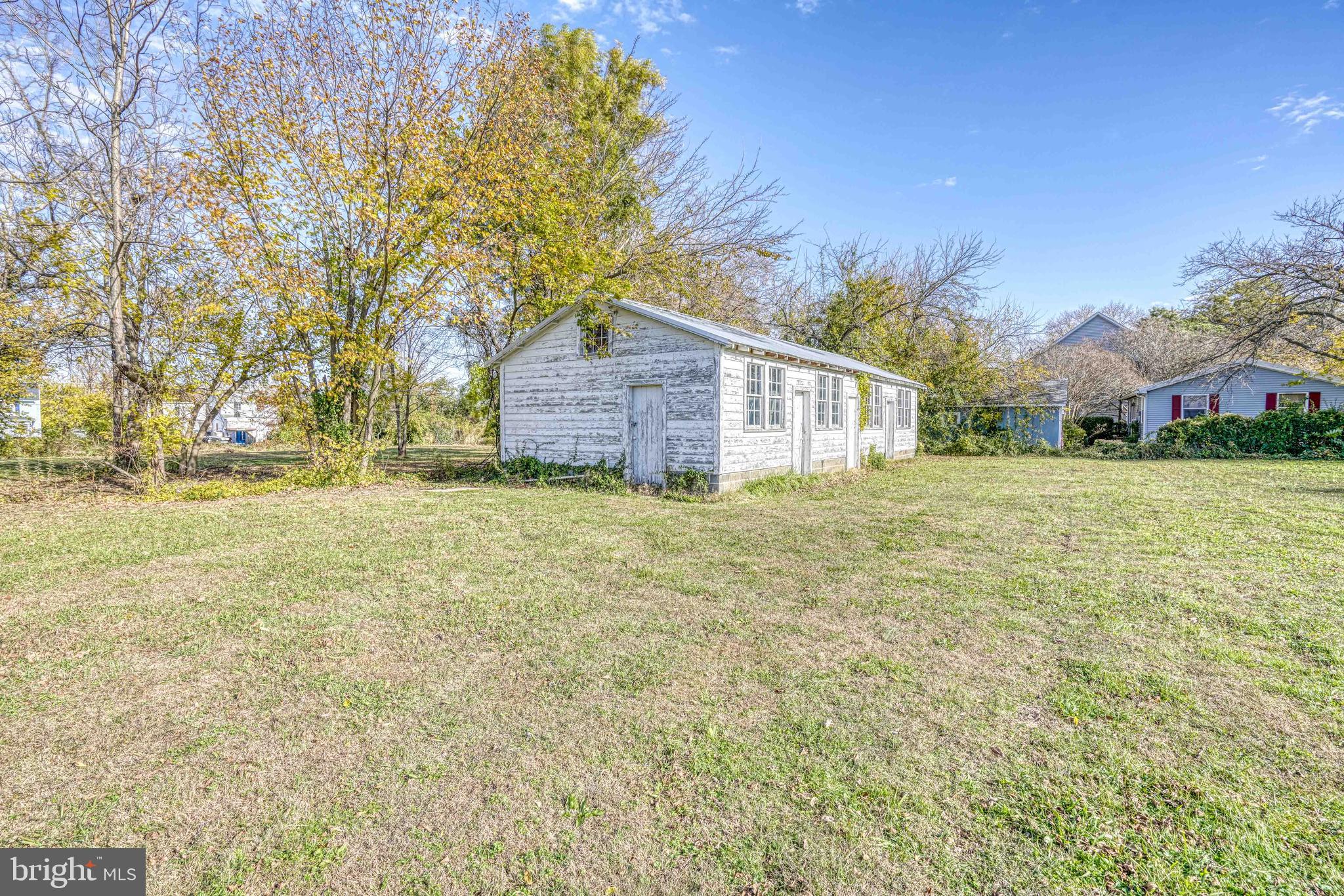 21486 Mission Road Tilghman, MD 21671 - Photo 21 of 32 a view of a house with a yard