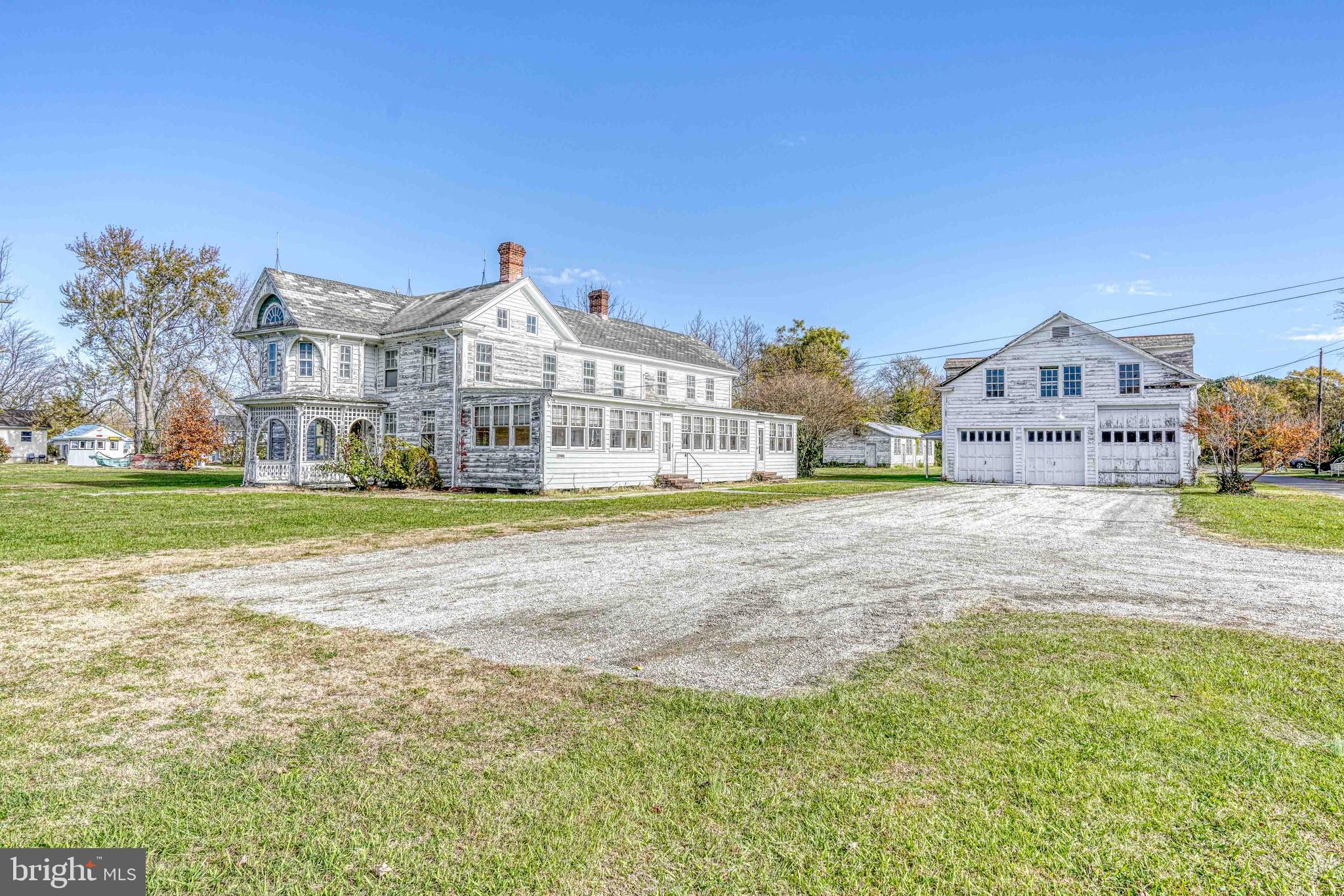 21486 Mission Road Tilghman, MD 21671 - Photo 4 of 32 a front view of a house with a yard