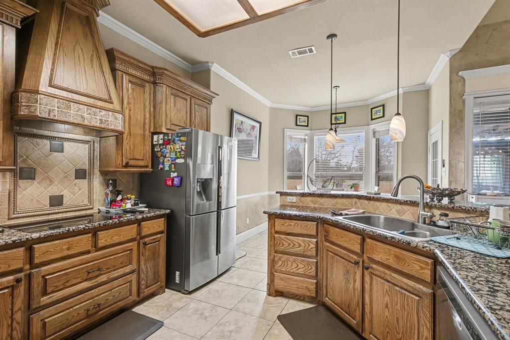 1361 Shallowbend Drive Midlothian, TX 76065 - Photo 11 of 30 a kitchen with stainless steel appliances granite countertop a sink and a refrigerator