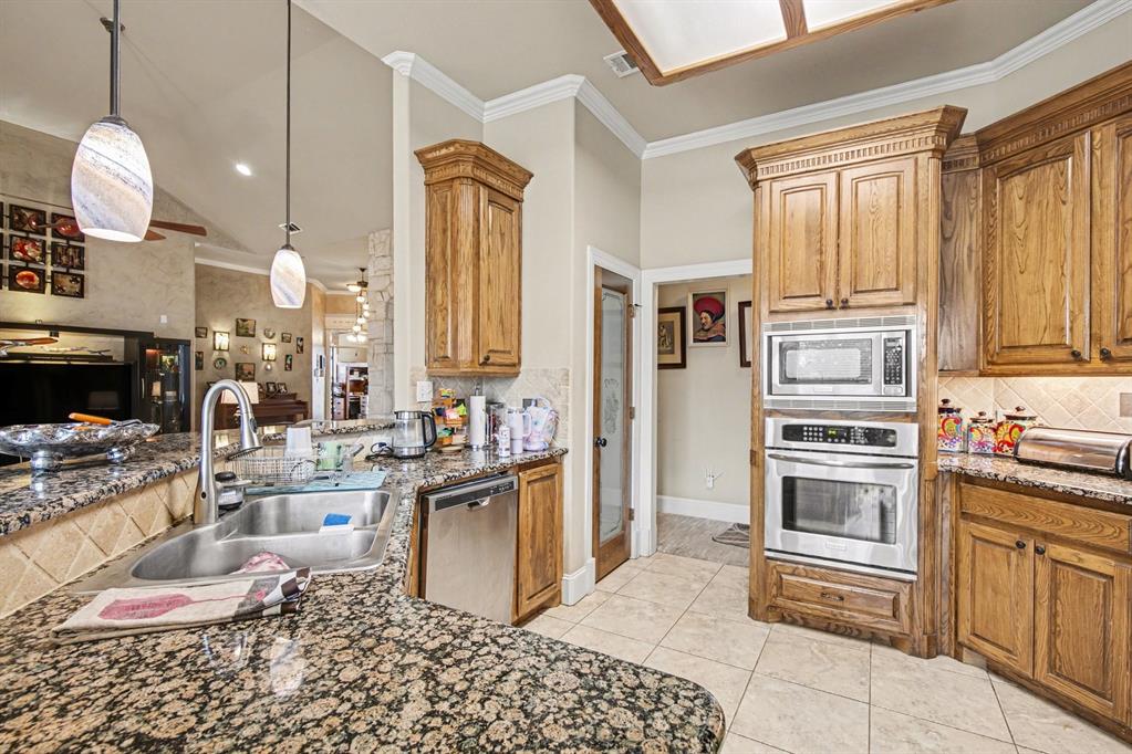 1361 Shallowbend Drive Midlothian, TX 76065 - Photo 12 of 30 a kitchen with stainless steel appliances granite countertop a stove a sink and a refrigerator