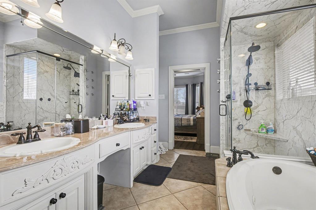 1361 Shallowbend Drive Midlothian, TX 76065 - Photo 17 of 30 a spacious bathroom with a sink double vanity granite tub shower and a mirror