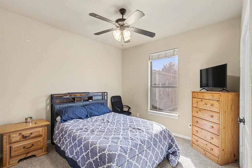 1361 Shallowbend Drive Midlothian, TX 76065 - Photo 18 of 30 a bedroom with a bed and a flat tv screen on dresser