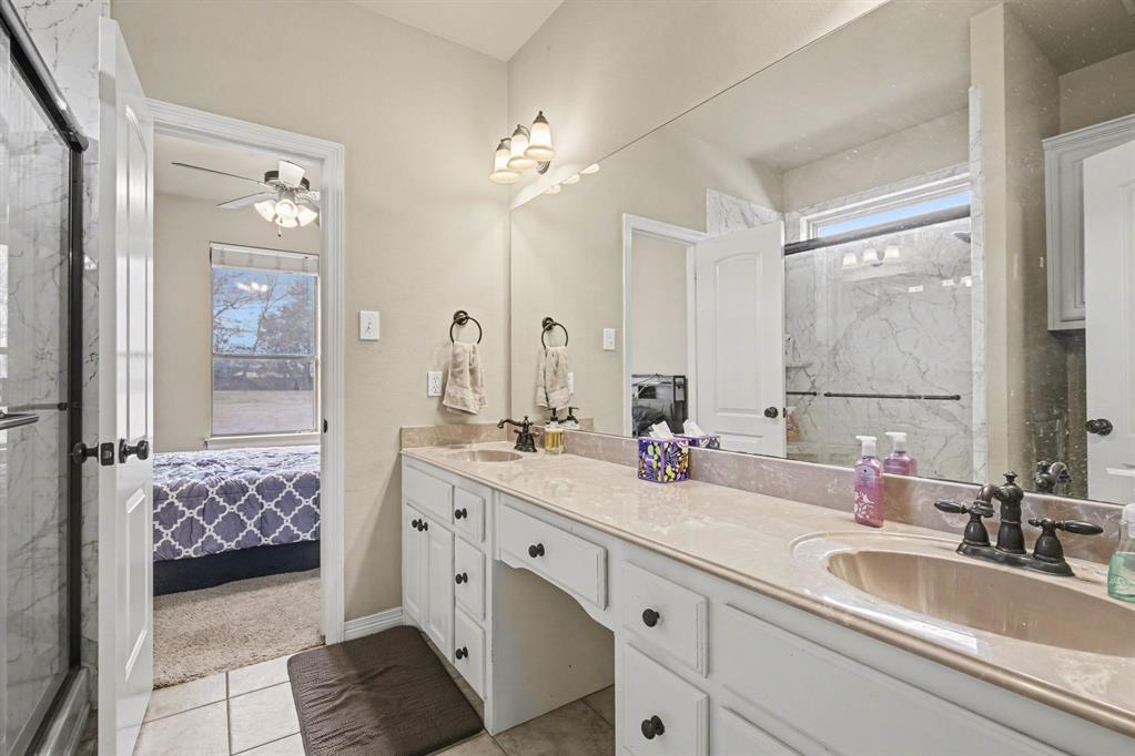 1361 Shallowbend Drive Midlothian, TX 76065 - Photo 19 of 30 a bathroom with a double vanity sink a large mirror and a shower