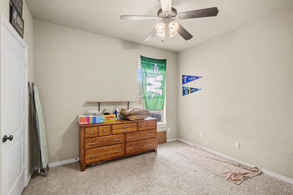 1361 Shallowbend Drive Midlothian, TX 76065 - Photo 21 of 30 a bedroom with a bed and a chandelier