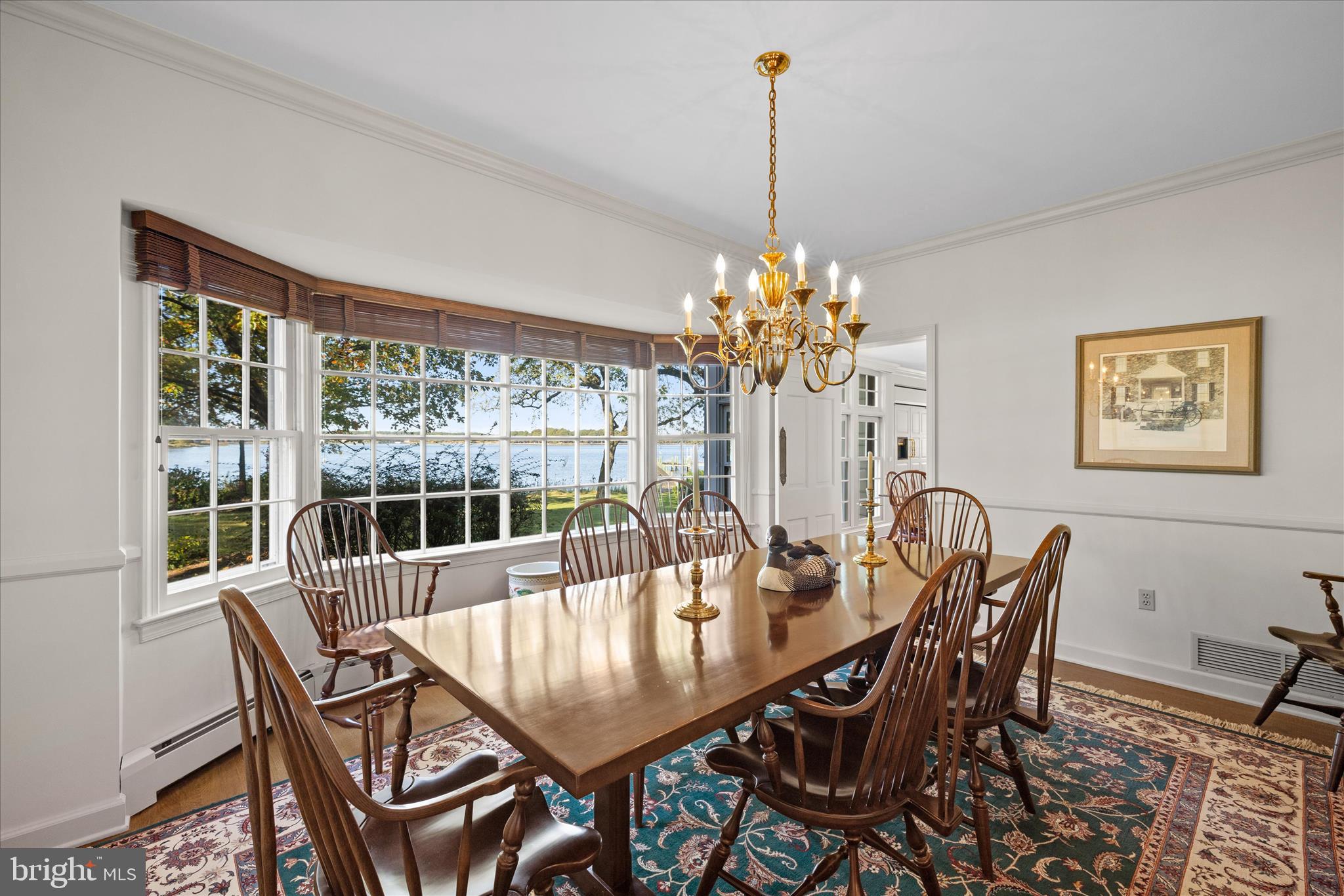 27473 Westpoint Road Easton, MD 21601 - Photo 12 of 58 a dining room with furniture a chandelier and wooden floor