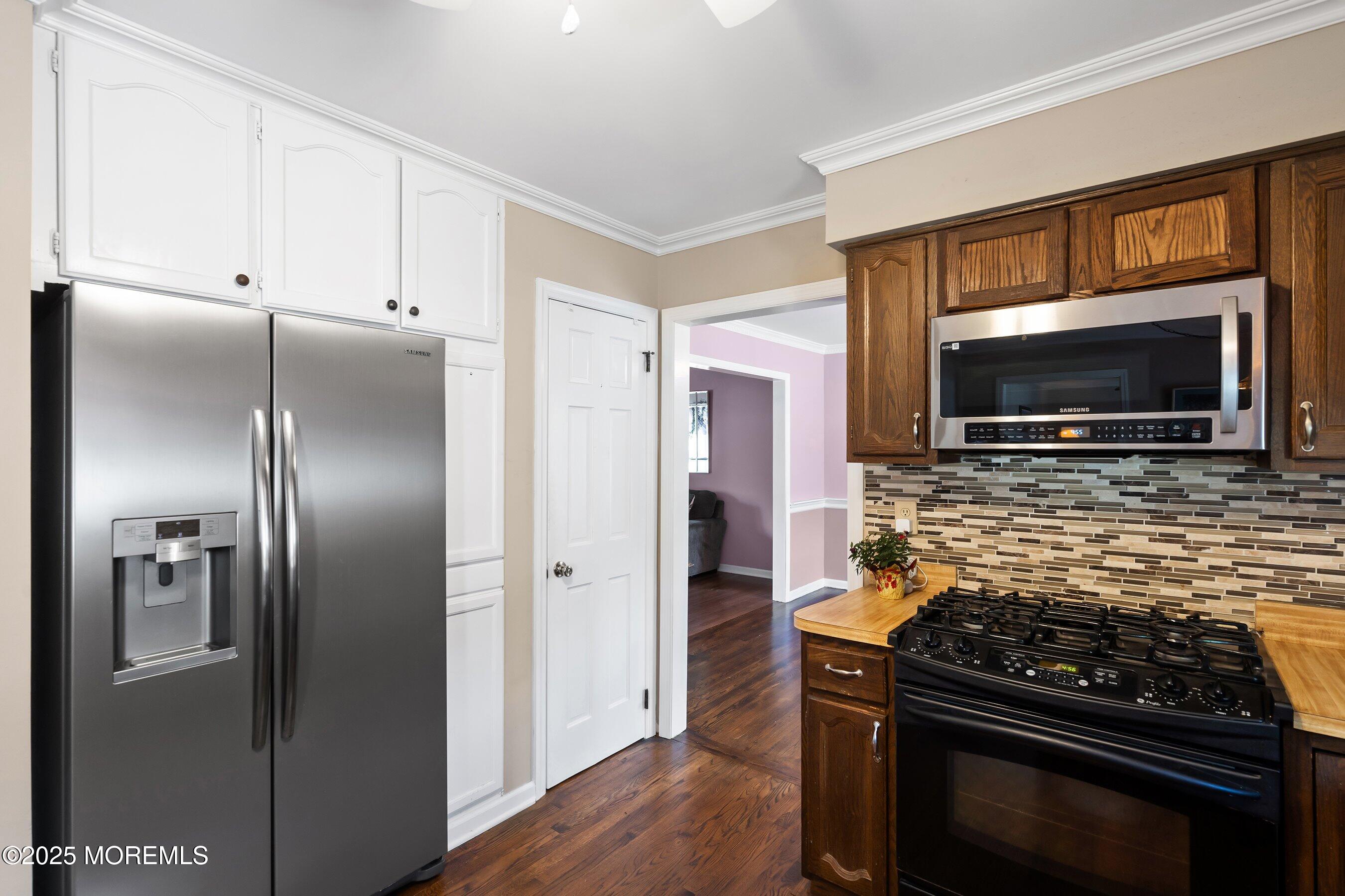 7 Spring Lake Avenue Oceanport, NJ 07757 - Photo 11 of 44 a kitchen with stainless steel appliances kitchen island granite countertop a stove a refrigerator and a microwave