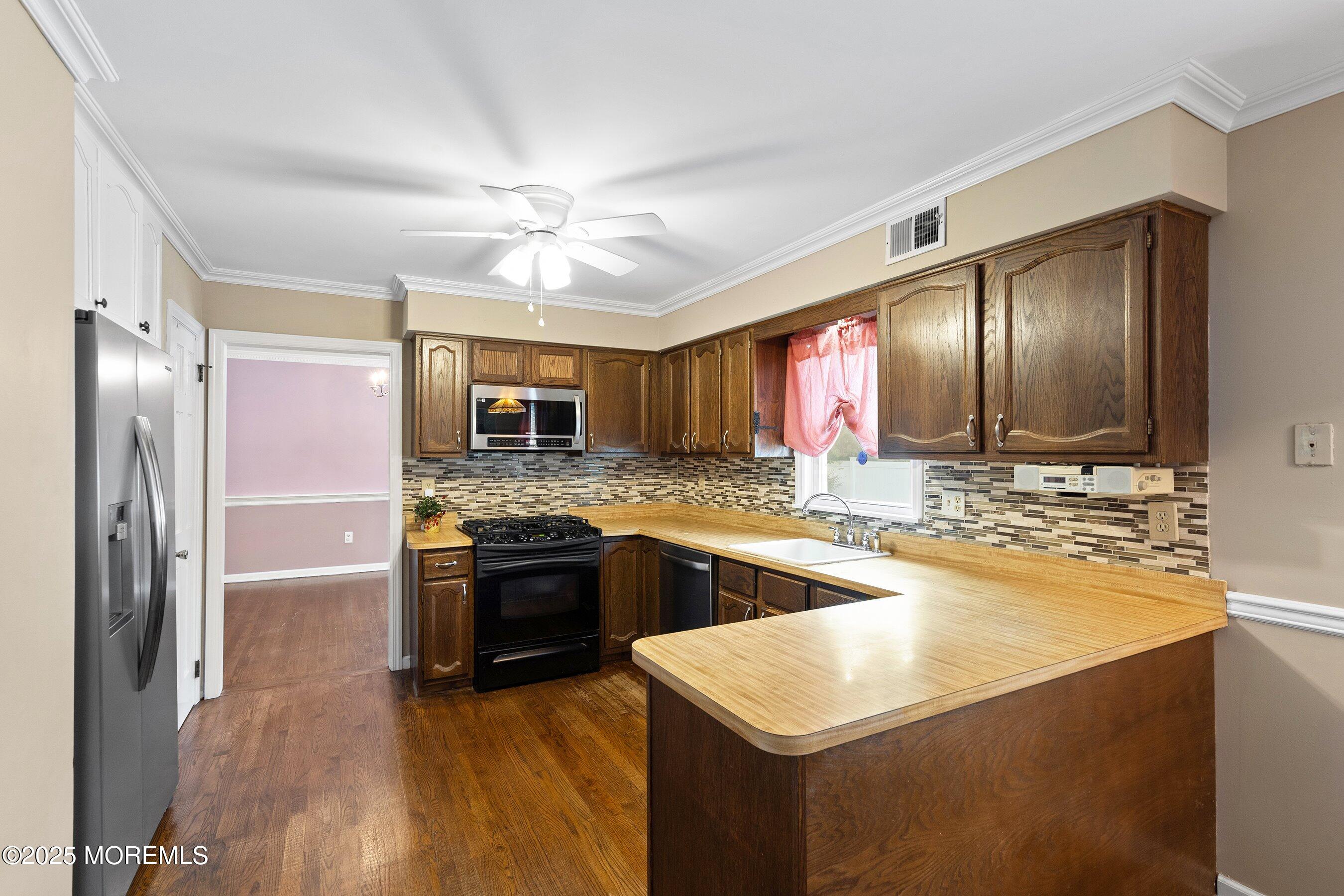 7 Spring Lake Avenue Oceanport, NJ 07757 - Photo 12 of 44 a kitchen with stainless steel appliances granite countertop a sink stove and refrigerator