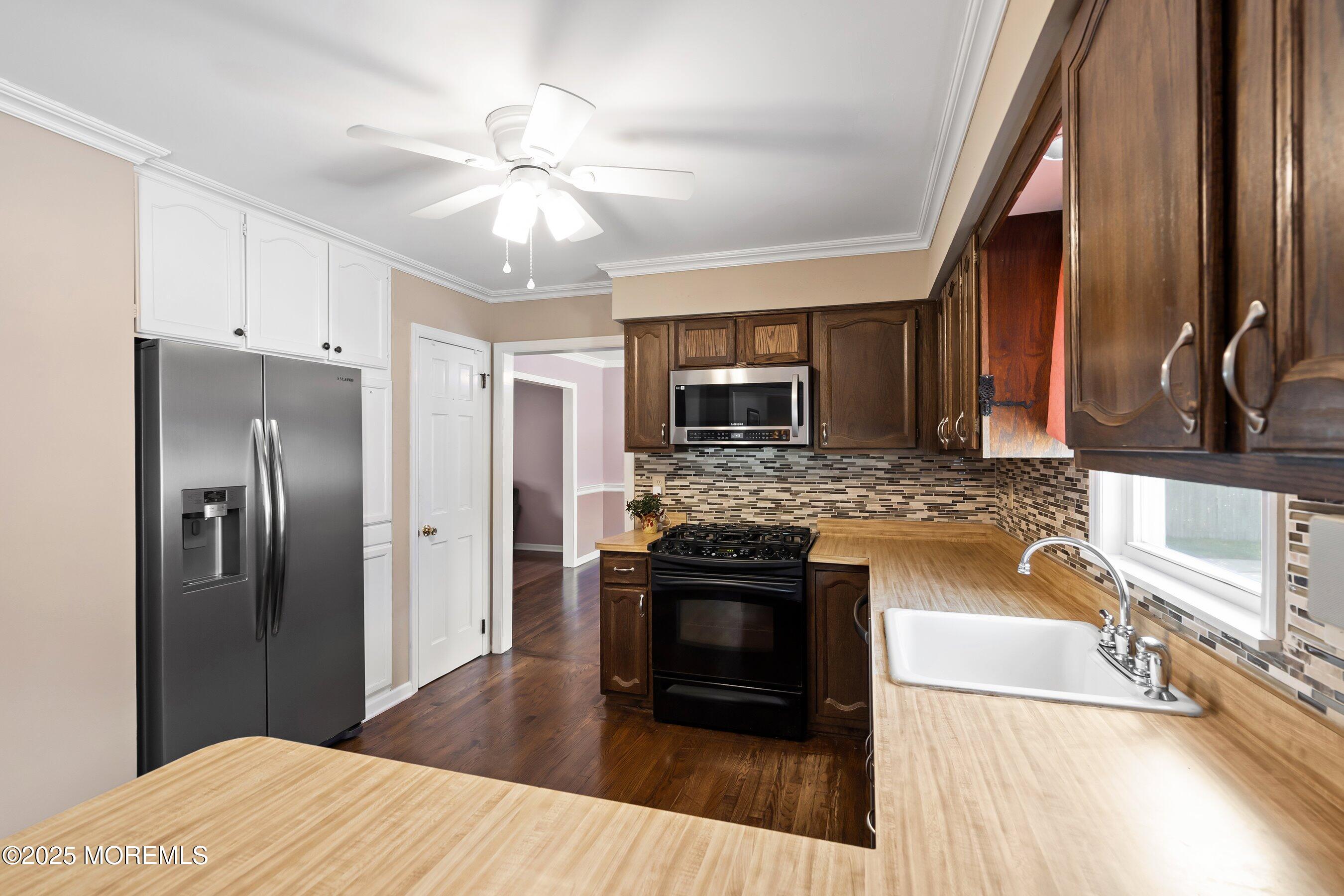 7 Spring Lake Avenue Oceanport, NJ 07757 - Photo 14 of 44 a kitchen with stainless steel appliances granite countertop a refrigerator a stove and a sink with wooden floor