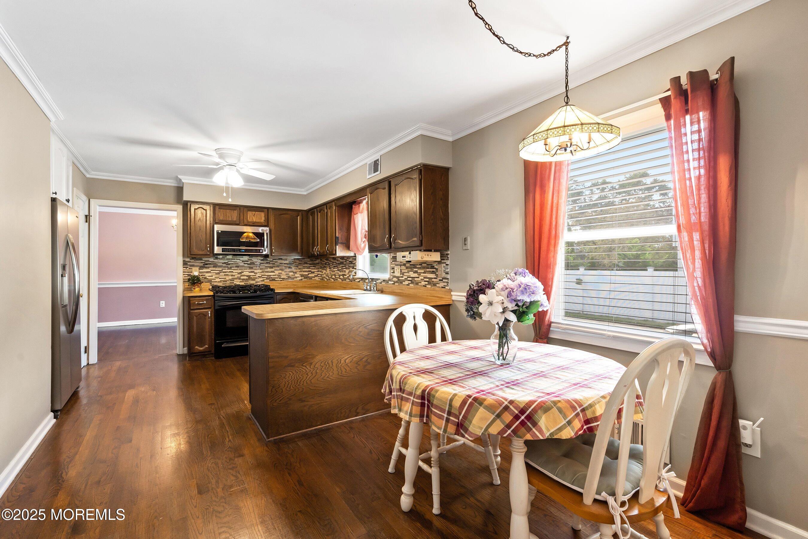 7 Spring Lake Avenue Oceanport, NJ 07757 - Photo 15 of 44 a kitchen with stainless steel appliances granite countertop a stove a refrigerator a kitchen island a sink dishwasher with a dining table and chair