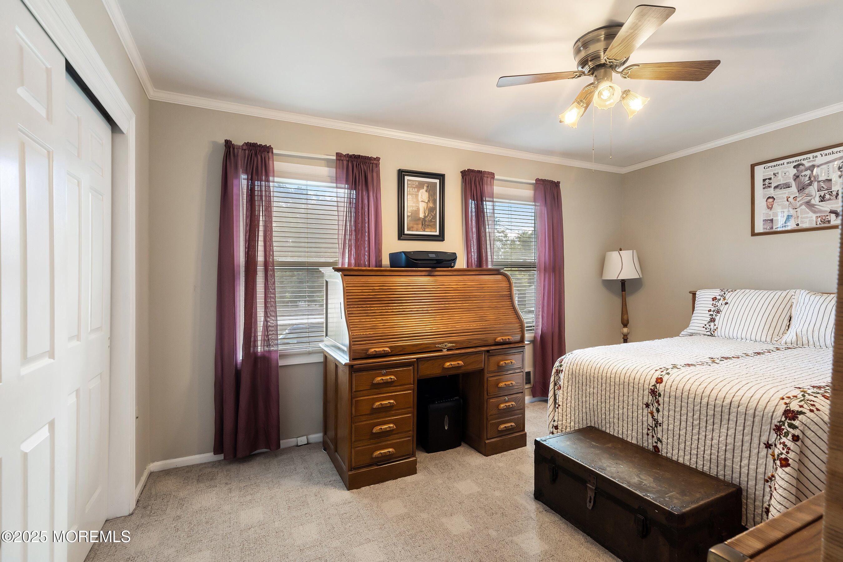 7 Spring Lake Avenue Oceanport, NJ 07757 - Photo 24 of 44 a bedroom with a bed and a chandelier