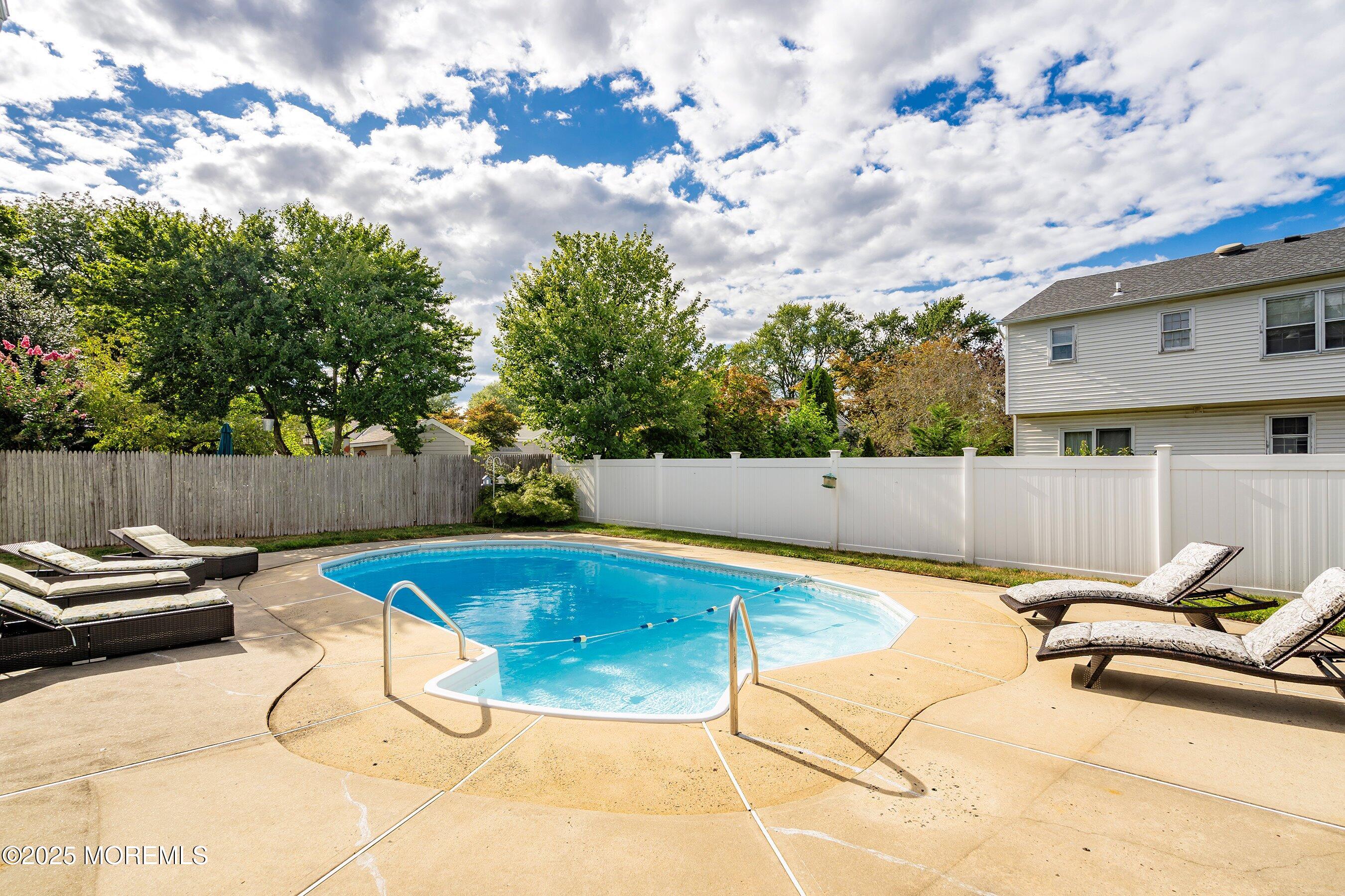 7 Spring Lake Avenue Oceanport, NJ 07757 - Photo 33 of 44 a view of a swimming pool with a lounge chairs