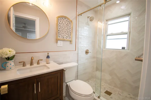 a bathroom with a sink a toilet and shower