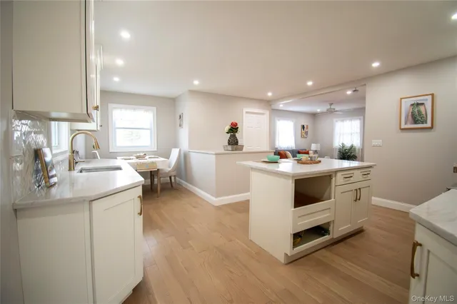 a kitchen with white cabinets and white appliances