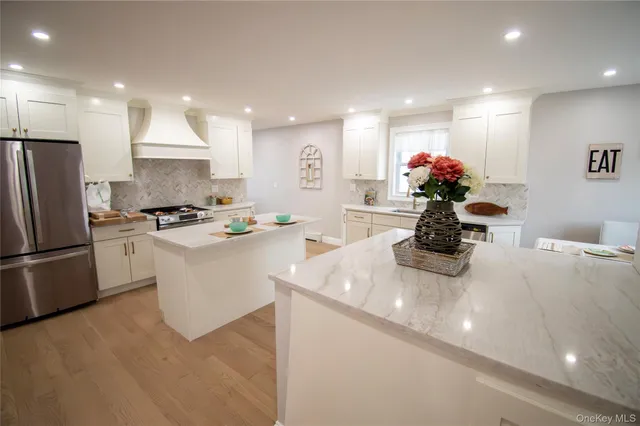 a kitchen with white cabinets and white appliances