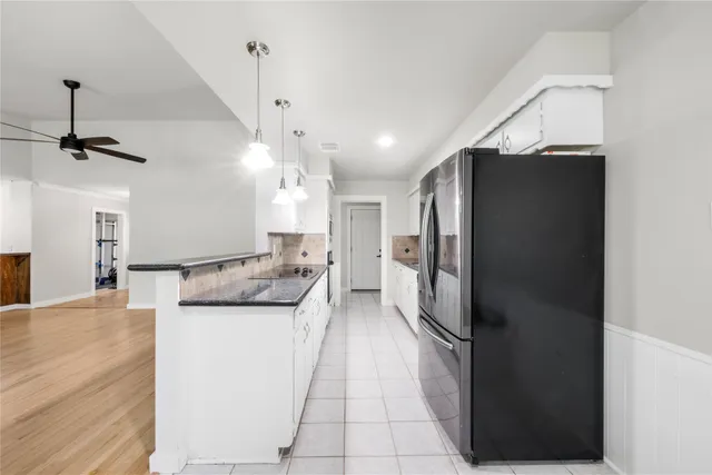 a kitchen with a refrigerator and a sink
