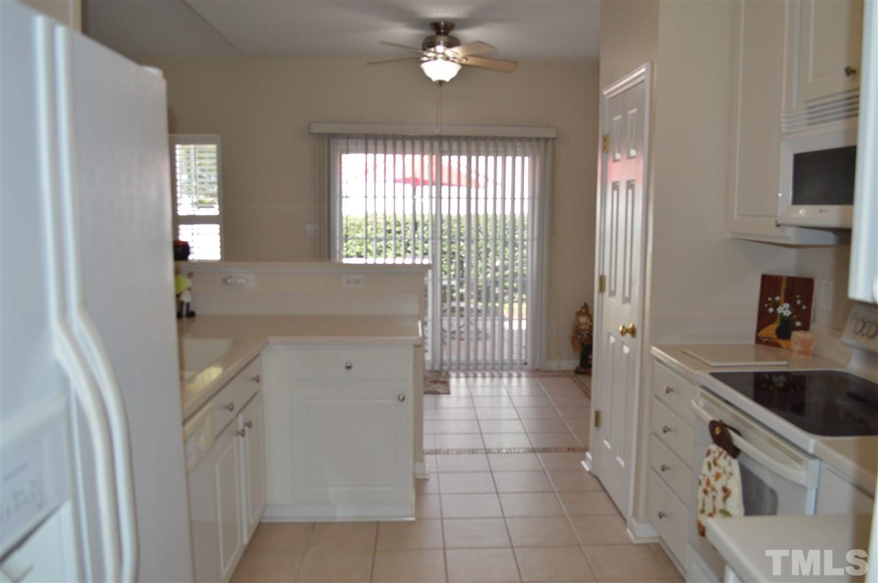 8508 Neuse Garden Drive Raleigh, NC 27616 - Photo 15 of 30 a kitchen with a sink a stove and cabinets
