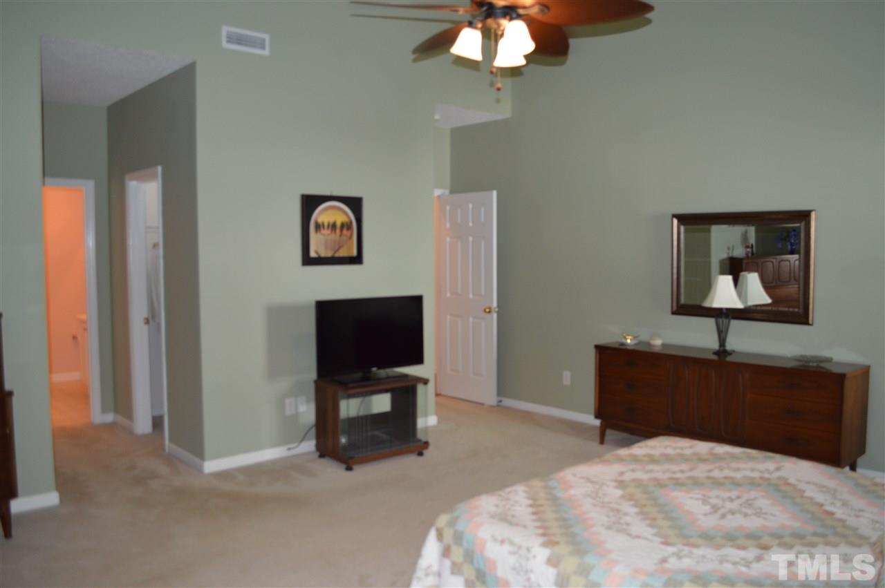 8508 Neuse Garden Drive Raleigh, NC 27616 - Photo 17 of 30 a bedroom with a bed and a flat screen tv
