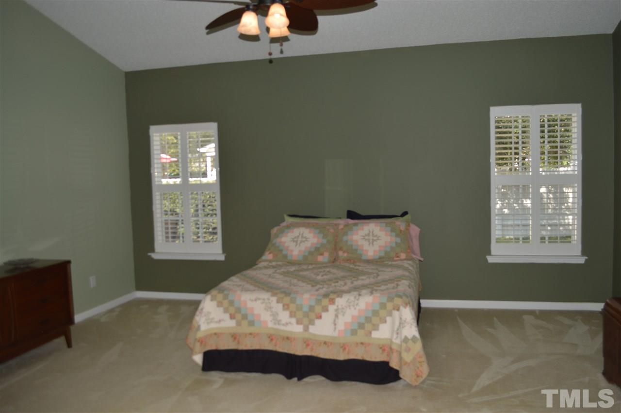 8508 Neuse Garden Drive Raleigh, NC 27616 - Photo 22 of 30 a bed in a room next to a window