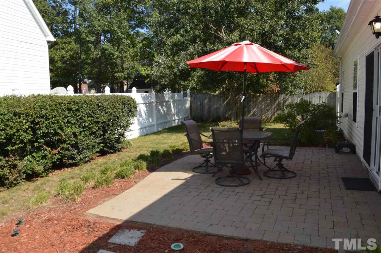 8508 Neuse Garden Drive Raleigh, NC 27616 - Photo 29 of 30 a view of a patio with table and chairs under an umbrella