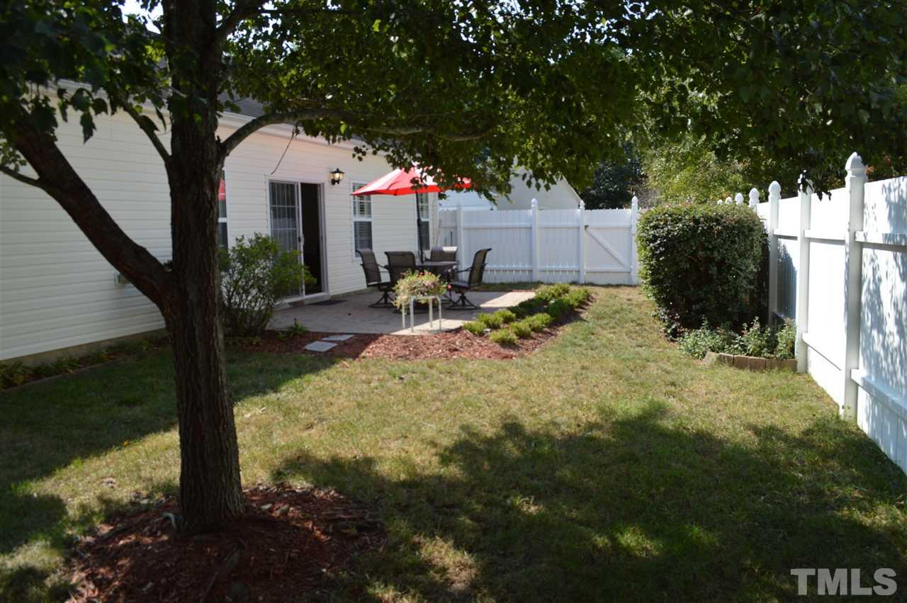 8508 Neuse Garden Drive Raleigh, NC 27616 - Photo 30 of 30 a view of backyard with a table and chairs and a large tree