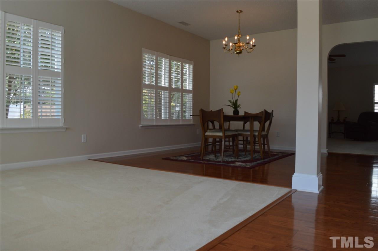 8508 Neuse Garden Drive Raleigh, NC 27616 - Photo 4 of 30 a living room with furniture and a chandelier