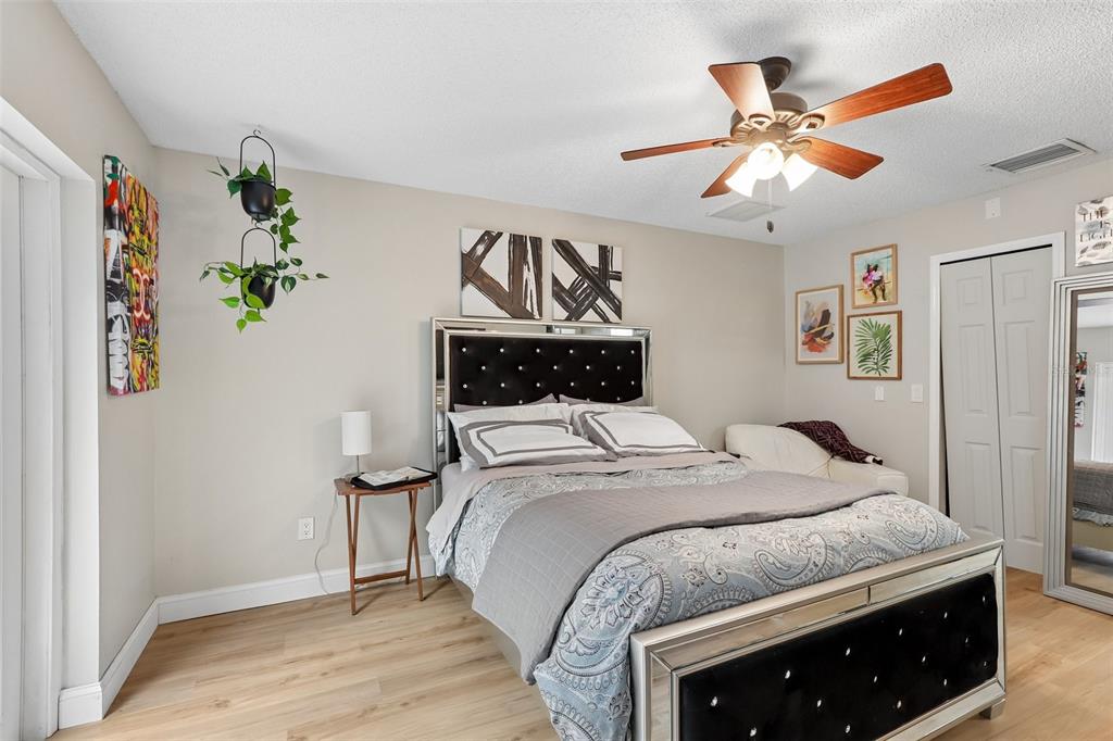 1525 Kestrel Way Brandon, FL 33511 - Photo 18 of 48 a bedroom with a bed and a chandelier