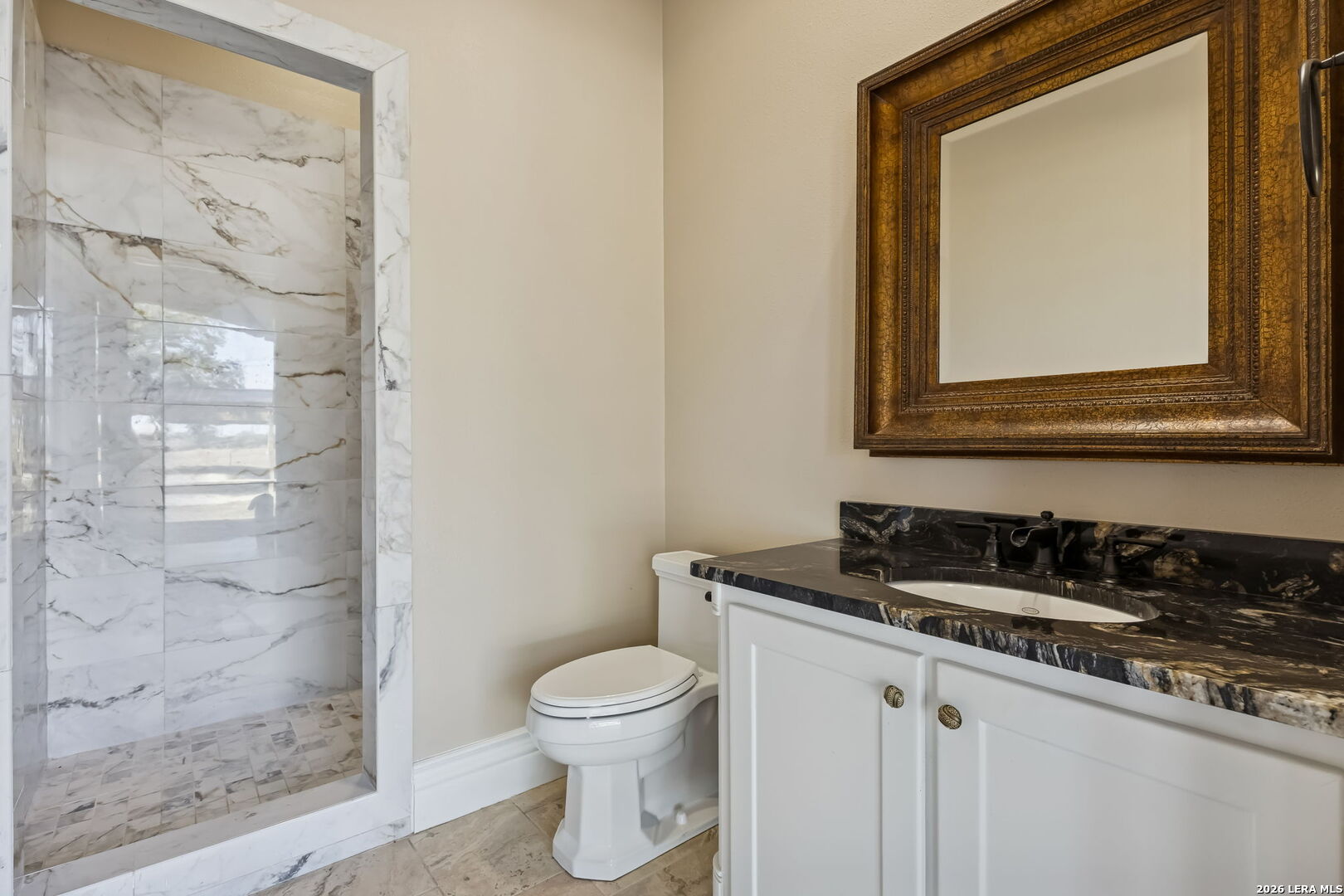 3128 Old St Marys Road Beeville, TX 78102 - Photo 47 of 50 a bathroom with a granite countertop sink a toilet and a mirror