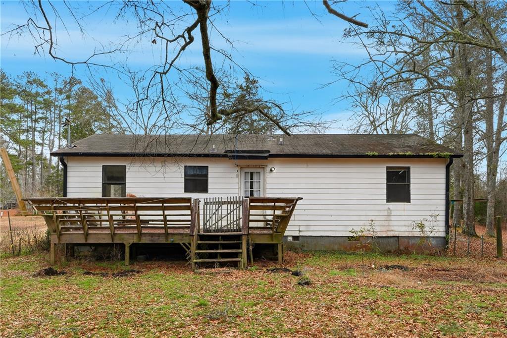 5685 Ashland Farm Road Oxford, GA 30054 - Photo 24 of 25 a backyard of a house with wooden deck patio and outdoor seating