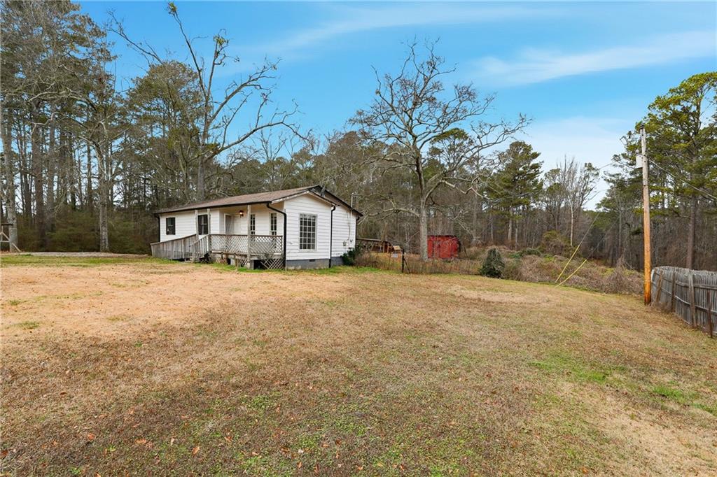 5685 Ashland Farm Road Oxford, GA 30054 - Photo 4 of 25 a front view of a house with a yard and garage
