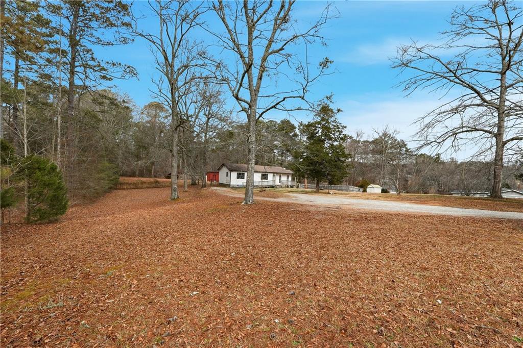 5685 Ashland Farm Road Oxford, GA 30054 - Photo 8 of 25 a view of dirt field with large trees