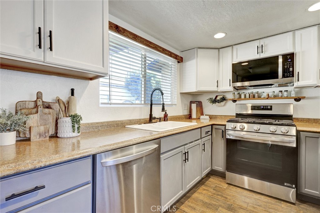 15936 Dauchy Avenue Riverside, CA 92508 - Photo 11 of 25 a kitchen with sink a stove and microwave