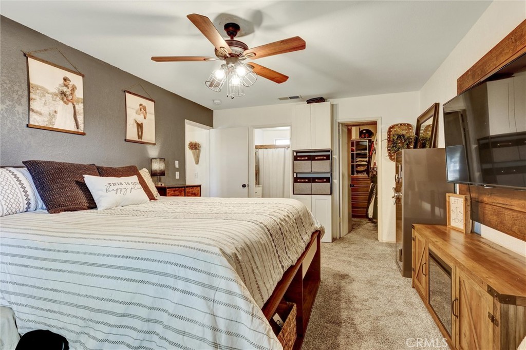 15936 Dauchy Avenue Riverside, CA 92508 - Photo 14 of 25 a bed room with bed and a tv