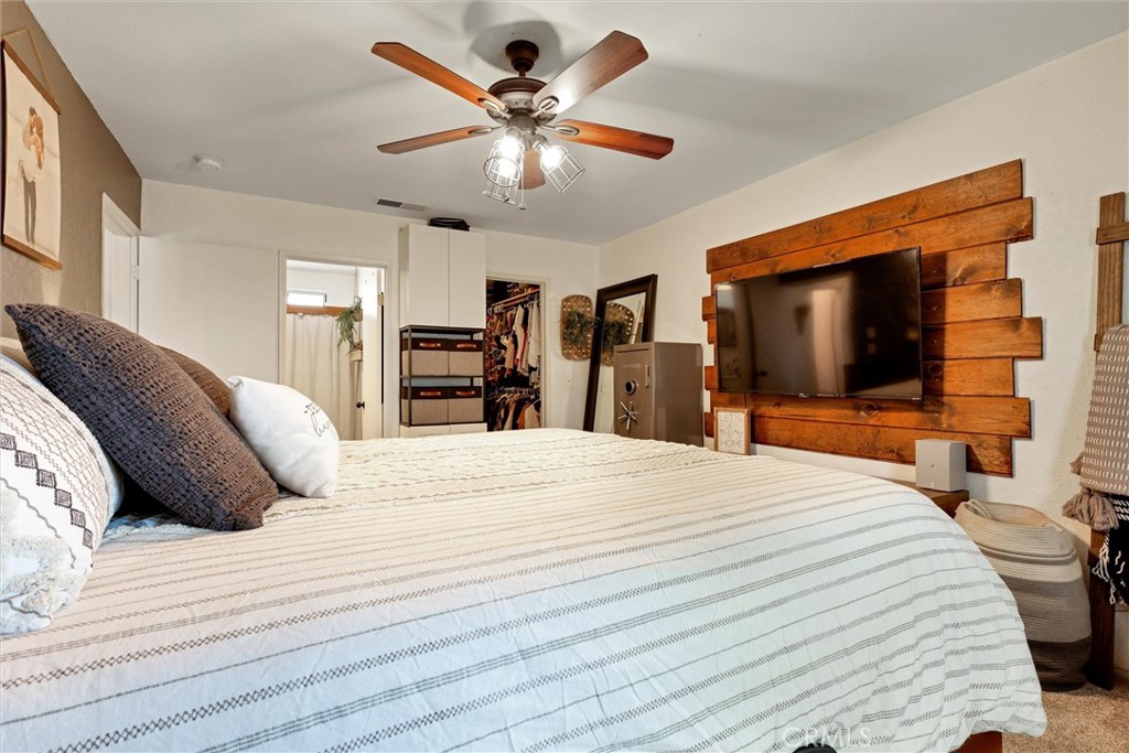 15936 Dauchy Avenue Riverside, CA 92508 - Photo 15 of 25 a large bedroom with a bed and a flat screen tv