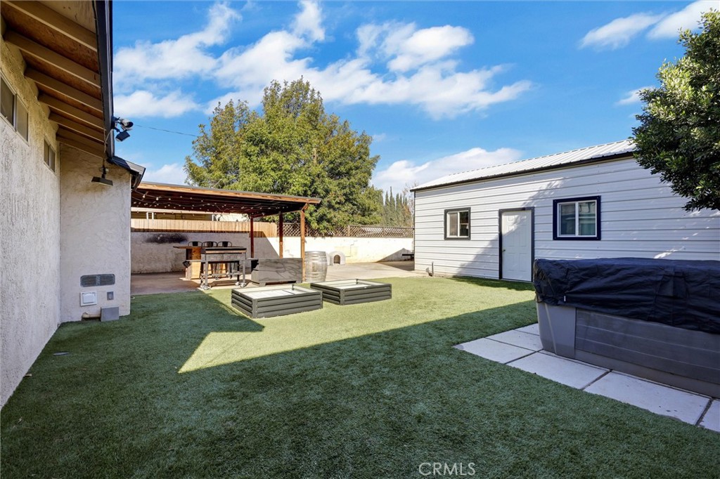 15936 Dauchy Avenue Riverside, CA 92508 - Photo 21 of 25 a view of a house with backyard sitting area and garden